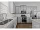 Modern kitchen with gray cabinets, granite counters, and island at 7840 Denmark Rd, Charlotte, NC 28273