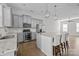 Modern kitchen with gray cabinets, granite counters, and island at 7840 Denmark Rd, Charlotte, NC 28273