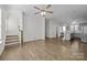 Open living room with hardwood floors, kitchen, and staircase at 7840 Denmark Rd, Charlotte, NC 28273