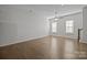 Bright living room featuring hardwood floors and a ceiling fan at 7840 Denmark Rd, Charlotte, NC 28273