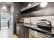 A modern butler's pantry, complete with dark cabinetry, marble countertops, and stainless steel appliances at 829 Palmetto Bay Dr, Fort Mill, SC 29715