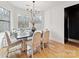 Bright dining area with large windows, hardwood floors, and a stylish chandelier at 829 Palmetto Bay Dr, Fort Mill, SC 29715