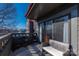 Outdoor balcony featuring seating and sliding glass doors offers a tranquil view of the lake and surrounding buildings at 9037 J M Keynes Dr # 23, Charlotte, NC 28262