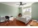 Cozy bedroom with hardwood floors, ceiling fan, desk, and a comfortable bed at 9037 J M Keynes Dr # 23, Charlotte, NC 28262