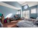 Bedroom with blue walls, carpet, and a large window at 9037 J M Keynes Dr # 23, Charlotte, NC 28262
