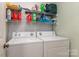 Laundry room with washer, dryer and shelving at 9037 J M Keynes Dr # 23, Charlotte, NC 28262