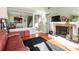 Open-concept living room with hardwood floors, a fireplace, and an integrated kitchen view at 9037 J M Keynes Dr # 23, Charlotte, NC 28262