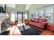 Cozy living room with a fireplace, hardwood flooring, and a sliding door to the outdoor patio at 9037 J M Keynes Dr # 23, Charlotte, NC 28262