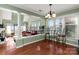 Bright living room with hardwood floors, large windows, and an open-concept design to the kitchen at 9037 J M Keynes Dr # 23, Charlotte, NC 28262