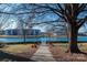Scenic path through lush landscaping leads to a serene lake view, ideal for relaxing walks at 9037 J M Keynes Dr # 23, Charlotte, NC 28262