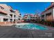The community swimming pool is framed by well-kept townhomes and lush landscaping at 9037 J M Keynes Dr # 23, Charlotte, NC 28262