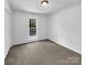 Well-lit bedroom with grey carpet and a window with exterior view at 918 Clover Park Dr, Clover, SC 29710