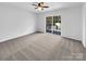 Bedroom with grey carpet, ceiling fan and sliding glass door to deck at 918 Clover Park Dr, Clover, SC 29710