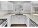 Modern kitchen featuring white cabinets, quartz countertops, and stainless steel appliances at 918 Clover Park Dr, Clover, SC 29710