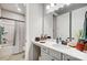 Well-lit bathroom featuring a shower-tub combo with a white vanity and ample counter space at 9428 Liberty Hill Dr, Mint Hill, NC 28227