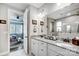 Double vanity bathroom with granite countertops and a view into the bedroom at 9428 Liberty Hill Dr, Mint Hill, NC 28227