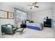 Cozy bedroom with carpet, a chair, a ceiling fan, two windows and simple decor at 9428 Liberty Hill Dr, Mint Hill, NC 28227