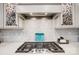 Gas cooktop with stylish backsplash and range hood at 9428 Liberty Hill Dr, Mint Hill, NC 28227