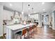 Bright kitchen featuring a large island with barstool seating, stainless appliances and white cabinetry at 9428 Liberty Hill Dr, Mint Hill, NC 28227