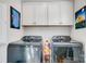 Laundry room featuring modern front-loading washer and dryer and above-cabinet storage at 9428 Liberty Hill Dr, Mint Hill, NC 28227