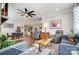 Open living room with hardwood floors, ceiling fan, and views into kitchen area at 9428 Liberty Hill Dr, Mint Hill, NC 28227