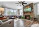 Living room with a stone fireplace and hardwood floors at 9428 Liberty Hill Dr, Mint Hill, NC 28227