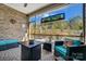 Inviting screened patio with stylish furniture, brick accent wall, and scenic backyard view at 9428 Liberty Hill Dr, Mint Hill, NC 28227