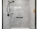 Modern bathroom with a glass shower stall, gray tile, rainfall shower head and a built-in shelf at 9428 Liberty Hill Dr, Mint Hill, NC 28227