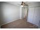 Carpeted bedroom with ceiling fan and double closets at 9445 Meadowmont View Dr # 137, Charlotte, NC 28269