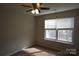 Bedroom with carpet, ceiling fan, and large window at 9445 Meadowmont View Dr # 137, Charlotte, NC 28269