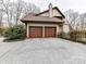 Two-car garage with concrete driveway and landscaping at 955 Brafford Dr, Concord, NC 28025