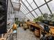 Greenhouse with various plants and gardening supplies at 955 Brafford Dr, Concord, NC 28025