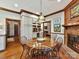 Kitchen breakfast area with a brick fireplace and hardwood floors at 955 Brafford Dr, Concord, NC 28025