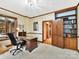 Home office with built-in bookcase and wood desk at 955 Brafford Dr, Concord, NC 28025