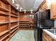 Basement pantry with wood shelving and a refrigerator at 955 Brafford Dr, Concord, NC 28025