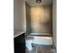 Modern bathroom features sleek gray tile and a built-in bathtub and shower at 963 North Shore Dr, Hickory, NC 28601