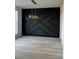 Dining room with hardwood flooring, dark accent wall, and a modern chandelier at 963 North Shore Dr, Hickory, NC 28601