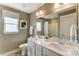 Bright bathroom with a double sink vanity, large mirror, and a window for natural light at 102 Ellsworth Rd # 43, Mooresville, NC 28115