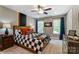 Stylish bedroom with a ceiling fan, large windows, checkered bedding, and colorful wall accents at 102 Ellsworth Rd # 43, Mooresville, NC 28115