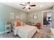 Cozy bedroom with butterfly themed wall art, soft carpet, and a ceiling fan at 102 Ellsworth Rd # 43, Mooresville, NC 28115