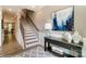 Bright foyer featuring elegant staircase, console table with decor, and stylish rug at 102 Ellsworth Rd # 43, Mooresville, NC 28115