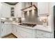 Modern kitchen featuring stainless steel hood, gray backsplash and quartz countertops at 102 Ellsworth Rd # 43, Mooresville, NC 28115