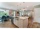 Open kitchen featuring a large island with seating, stainless steel appliances, and a seamless flow to living spaces at 102 Ellsworth Rd # 43, Mooresville, NC 28115