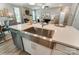 Spacious kitchen with a stainless steel sink, quartz countertops, and an open design to the living areas at 102 Ellsworth Rd # 43, Mooresville, NC 28115