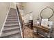 Grand staircase with wrought iron railing leading to the upper level at 10315 Samuels Way Dr, Huntersville, NC 28078