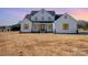 Two story farmhouse with white siding, dark roof, and landscaping at 1085 Rolling Meadows Dr, Mooresville, NC 28115