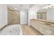 Elegant bathroom with double vanity, soaking tub, and shower at 16908 Bridgewalk Dr, Charlotte, NC 28277