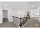 Upstairs hallway with carpet flooring and access to bedrooms at 16908 Bridgewalk Dr, Charlotte, NC 28277