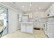 Bright eat-in kitchen with white cabinets, island, and sliding glass door to patio at 2944 Caldwell Ridge Pkwy, Charlotte, NC 28213