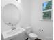 Well-lit half bathroom with a classic pedestal sink and simple, elegant design at 3116 Beacon Heights Rd, Indian Land, SC 29707